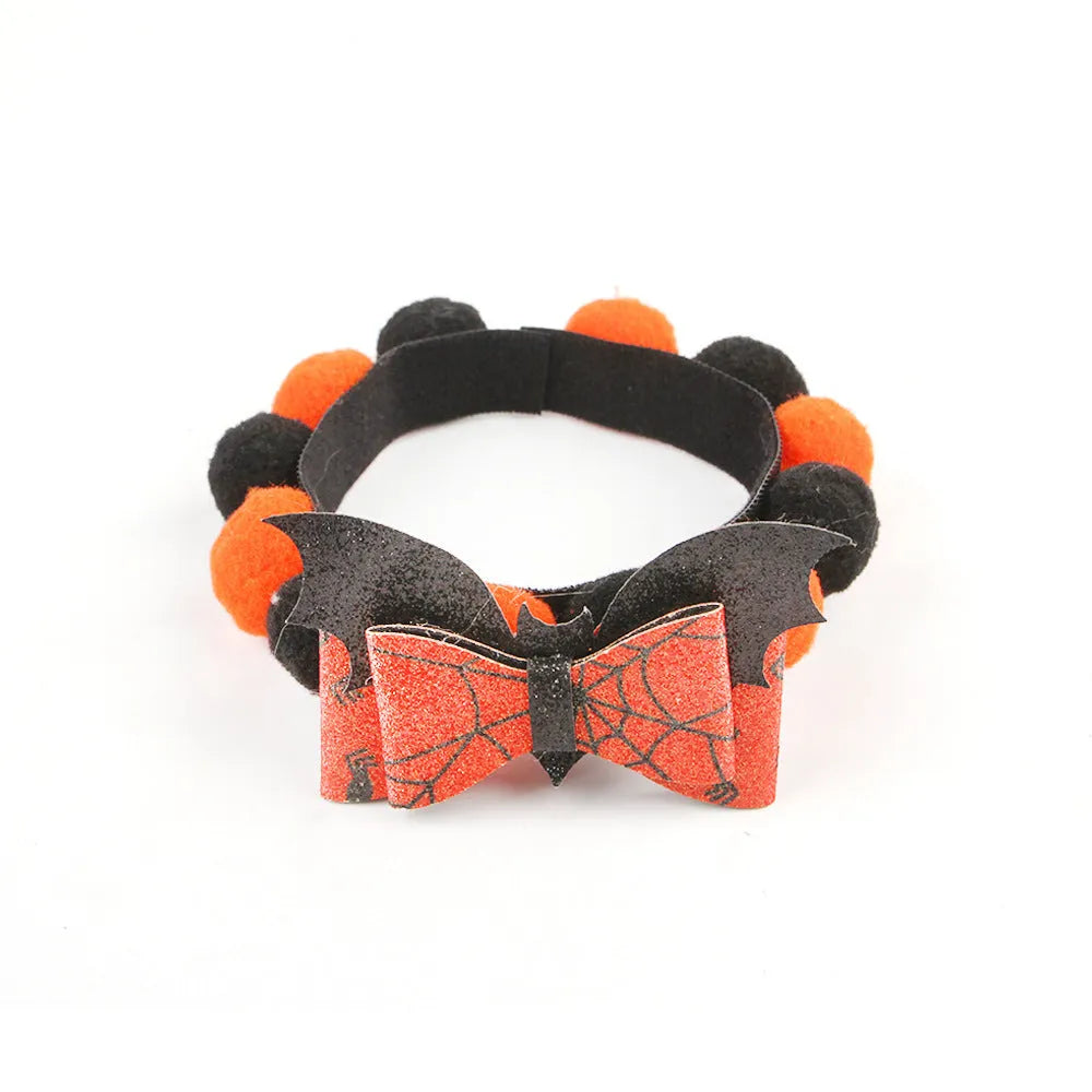 Halloween pet collar with soft fur ball pumpkin accessory in orange, sized on a dog's neck.
