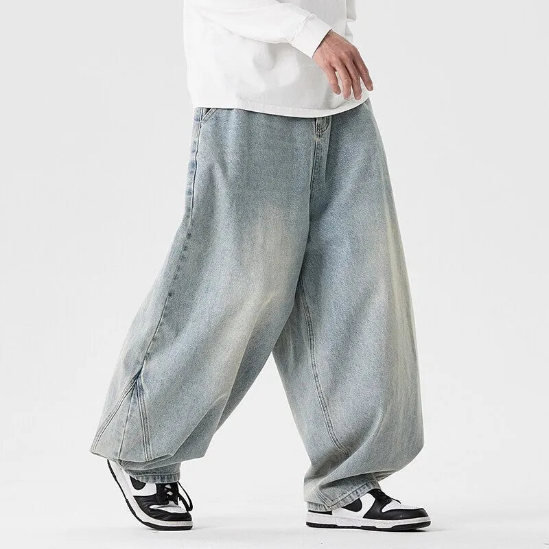 Men's plus size baggy wide leg jeans in light blue denim laid flat