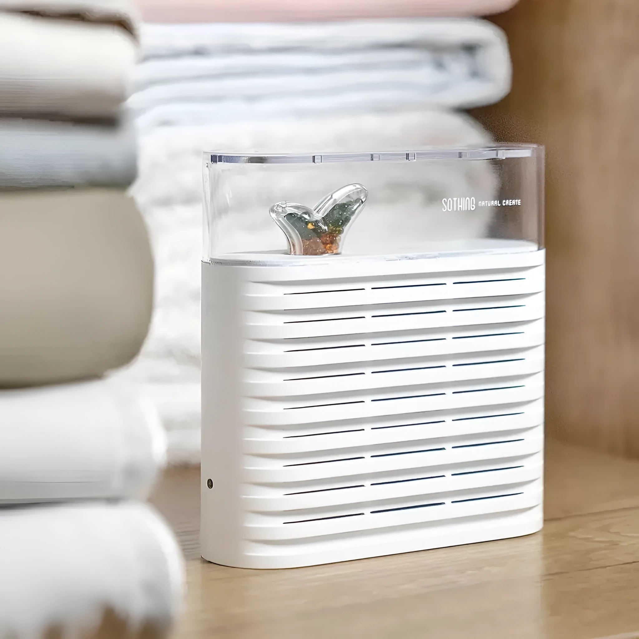 White recyclable electric dehumidifier box for cabinets with transparent top showing orange silica gel crystals.