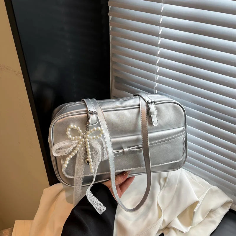 Single-shoulder flap bag in horizontal square shape with bow decoration and internal phone compartment
