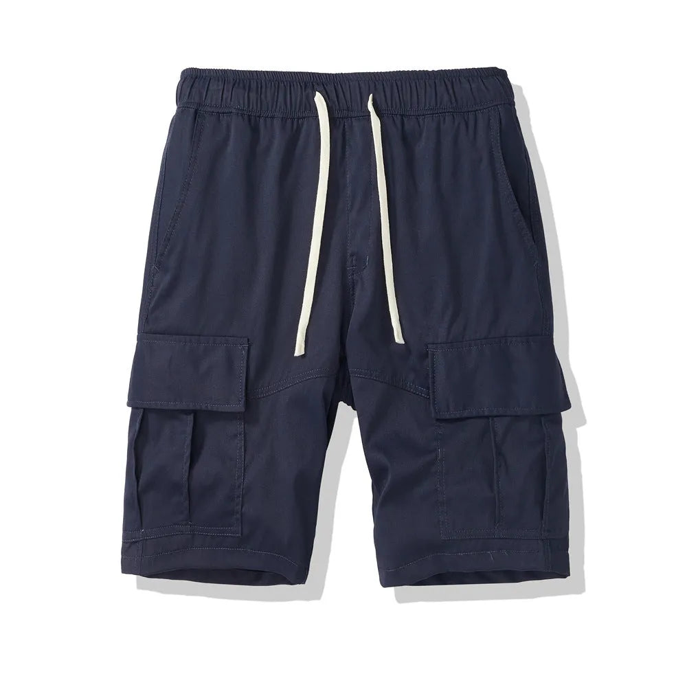 Man wearing loose-fit black cropped trousers with multiple pockets, summer casual style
