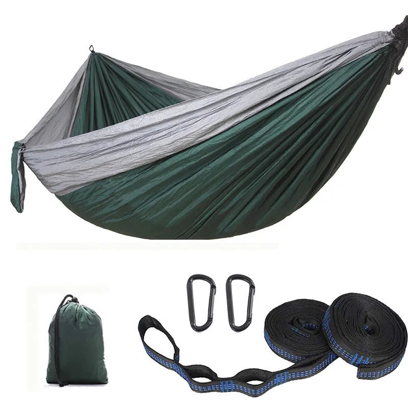 Double camping hammock with ropes and buckles shown in outdoor setting