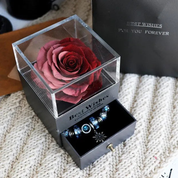 Eternal Flower gift box with preserved roses and carnations inside, measuring 8.5 cm square by 10.5 cm high