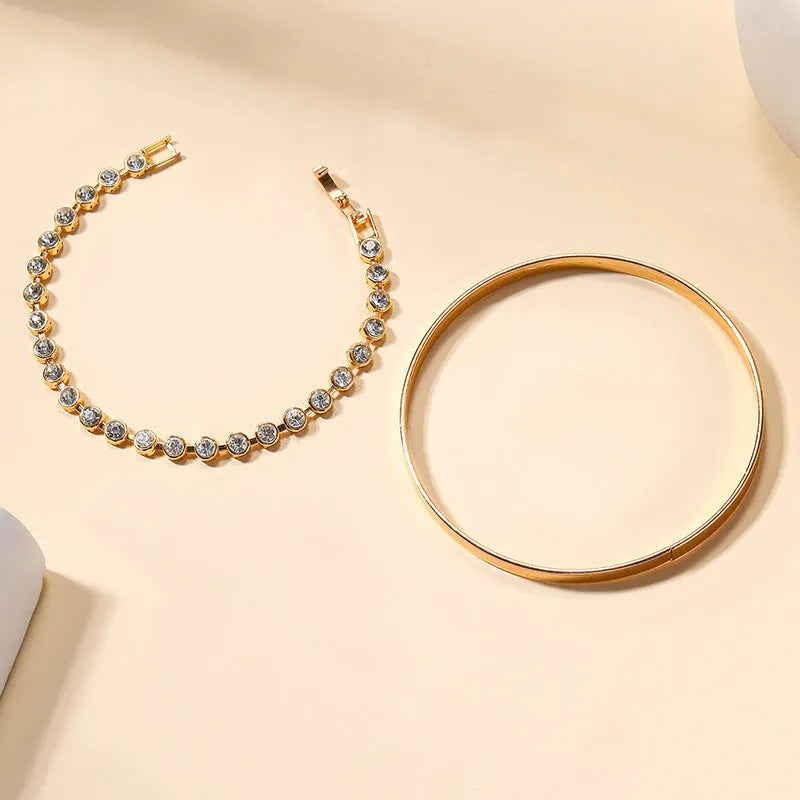 Gold and silver zinc alloy vintage bracelet set with drop-shaped geometric links on a white background