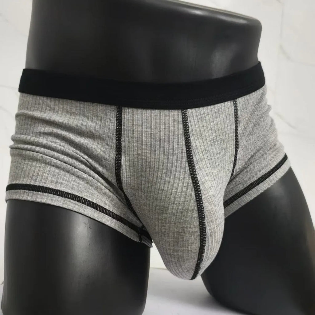 Solid colour men's boxers on a white background, showing thin breathable fabric and body-shaping fit.