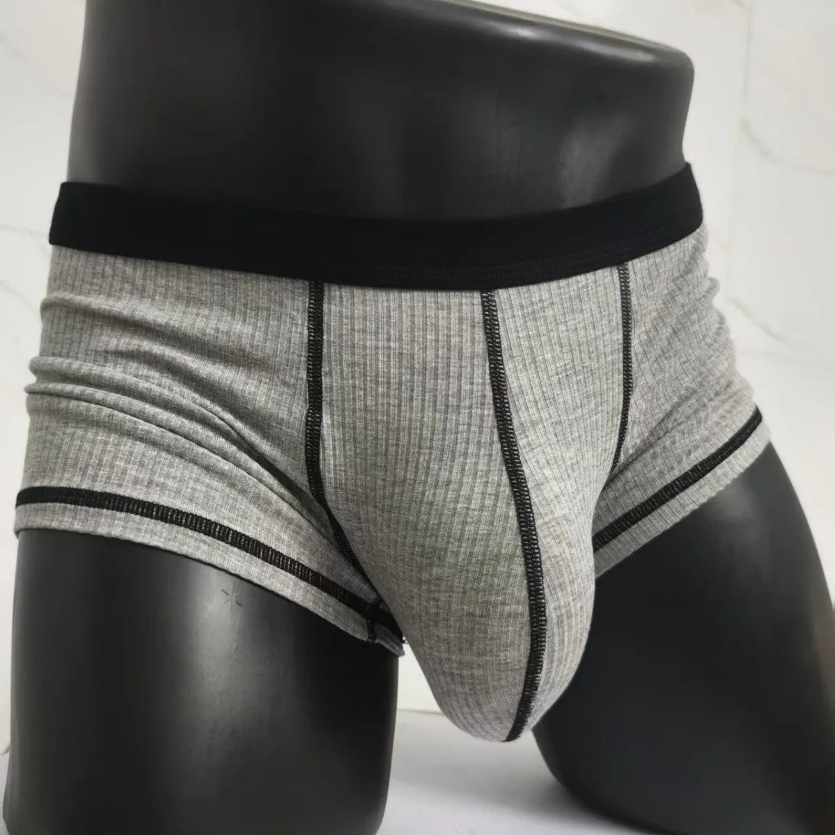 Solid colour men's boxers on a white background, showing thin breathable fabric and body-shaping fit.