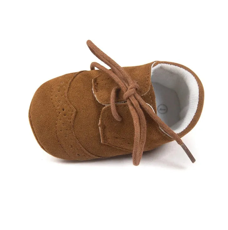 Vintage style soft-soled baby shoes for boys in synthetic leather, available in black, grey, light brown, and white.