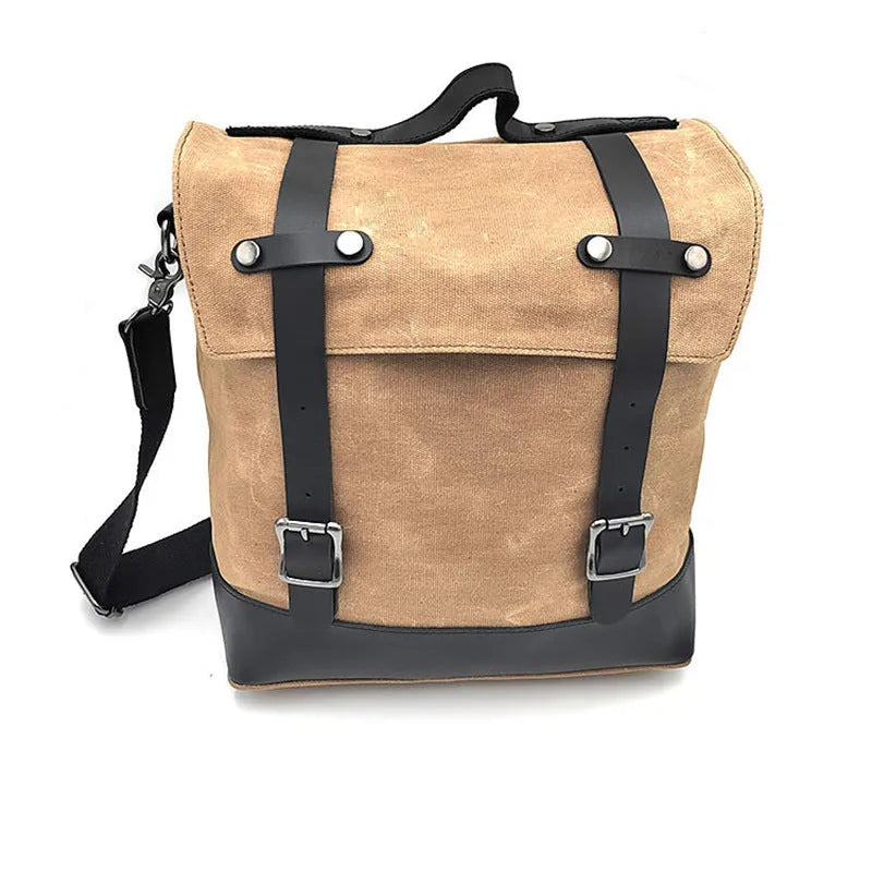 Waterproof canvas motorcycle side pannier bag in black mounted to motorcycle