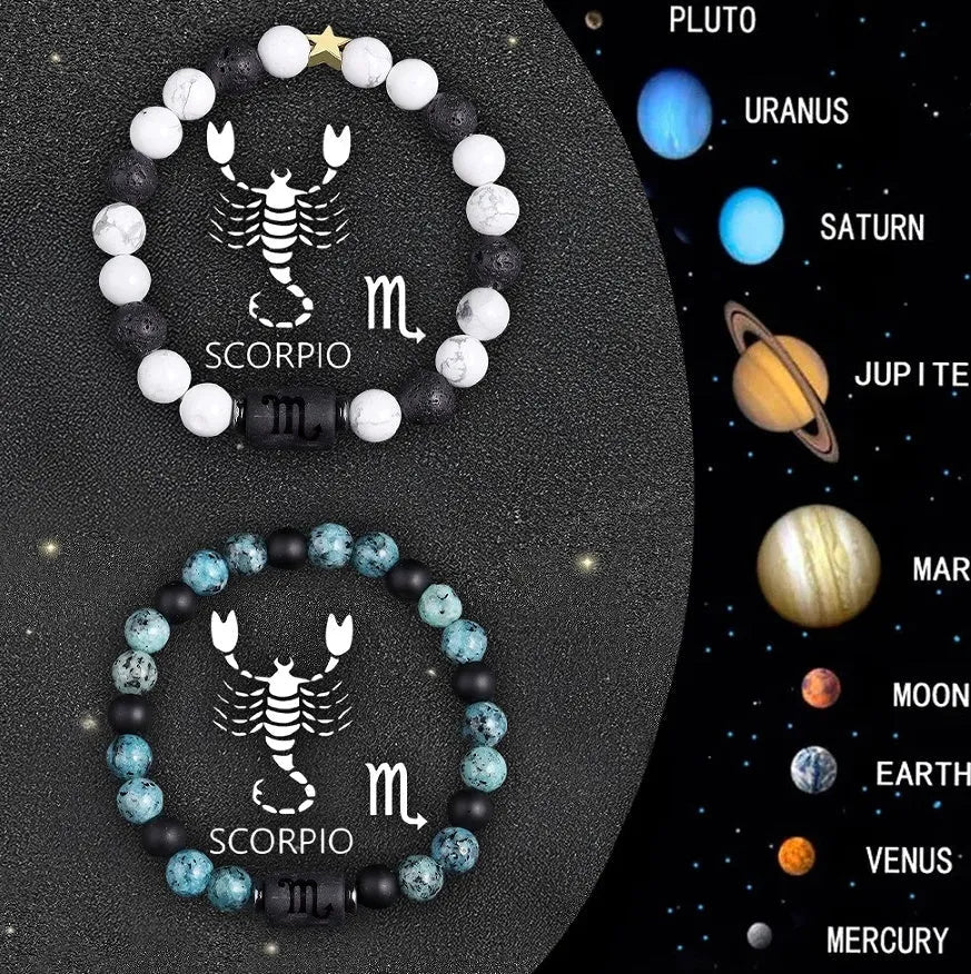 Two natural stone beaded zodiac bracelets with adjustable strings on wooden surface