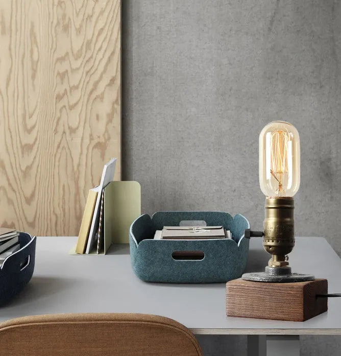 Industrial water pipe table lamp with wood and iron construction on tabletop