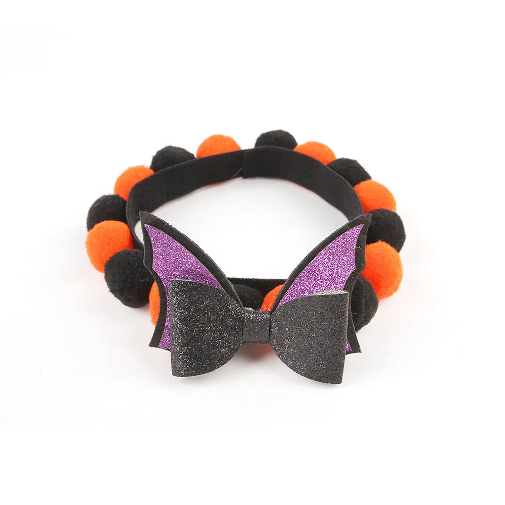 Halloween pet collar with soft fur ball pumpkin accessory in orange, sized on a dog's neck.