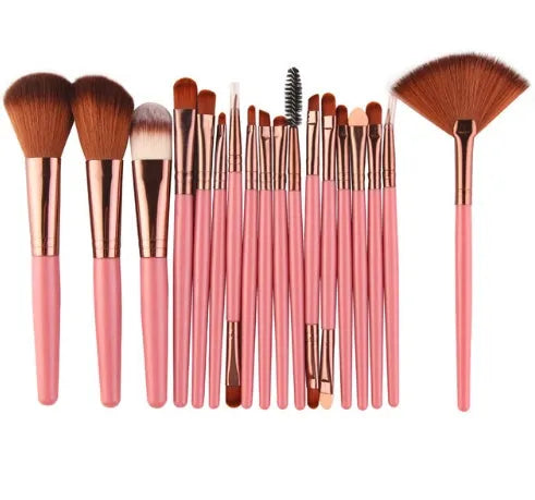 18-piece makeup brush set with fan brushes arranged on a table.