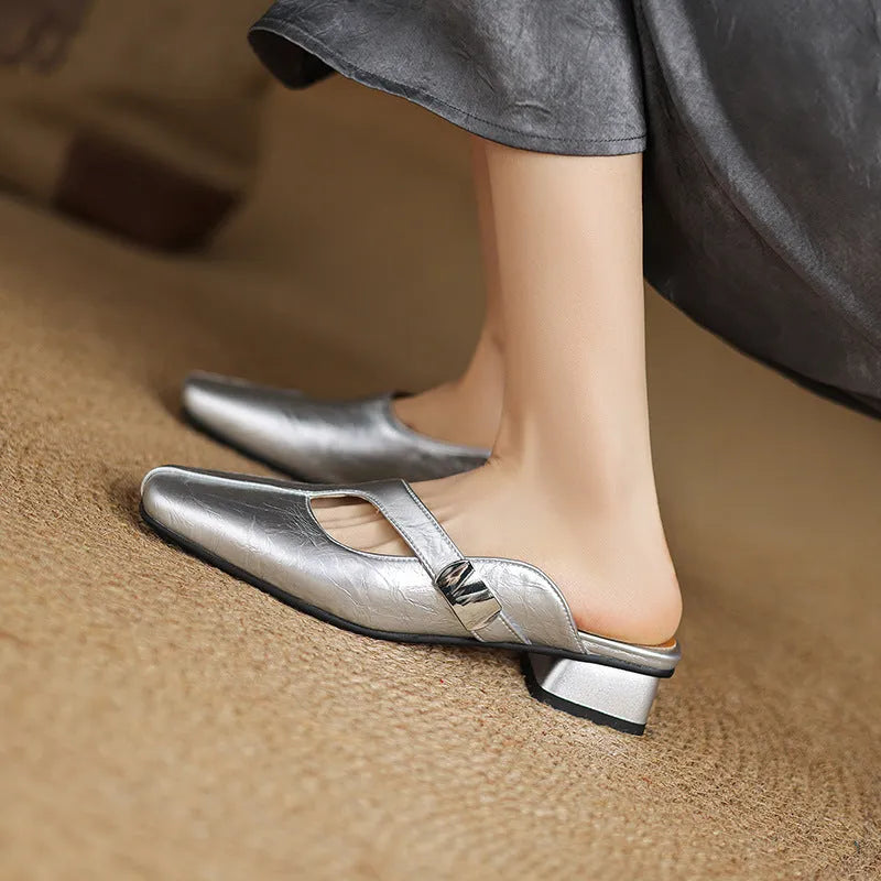 Pair of square-toe casual slippers with a low heel on a rubber sole, shown in a solid colour.