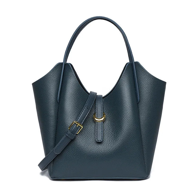 Genuine leather women's retro bucket handbag in beige with top handles and visible stitching.