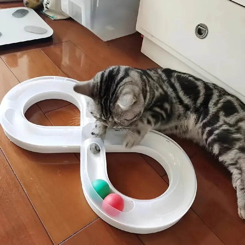 Rotating cat track toy with rolling balls and teasing stick on blue background