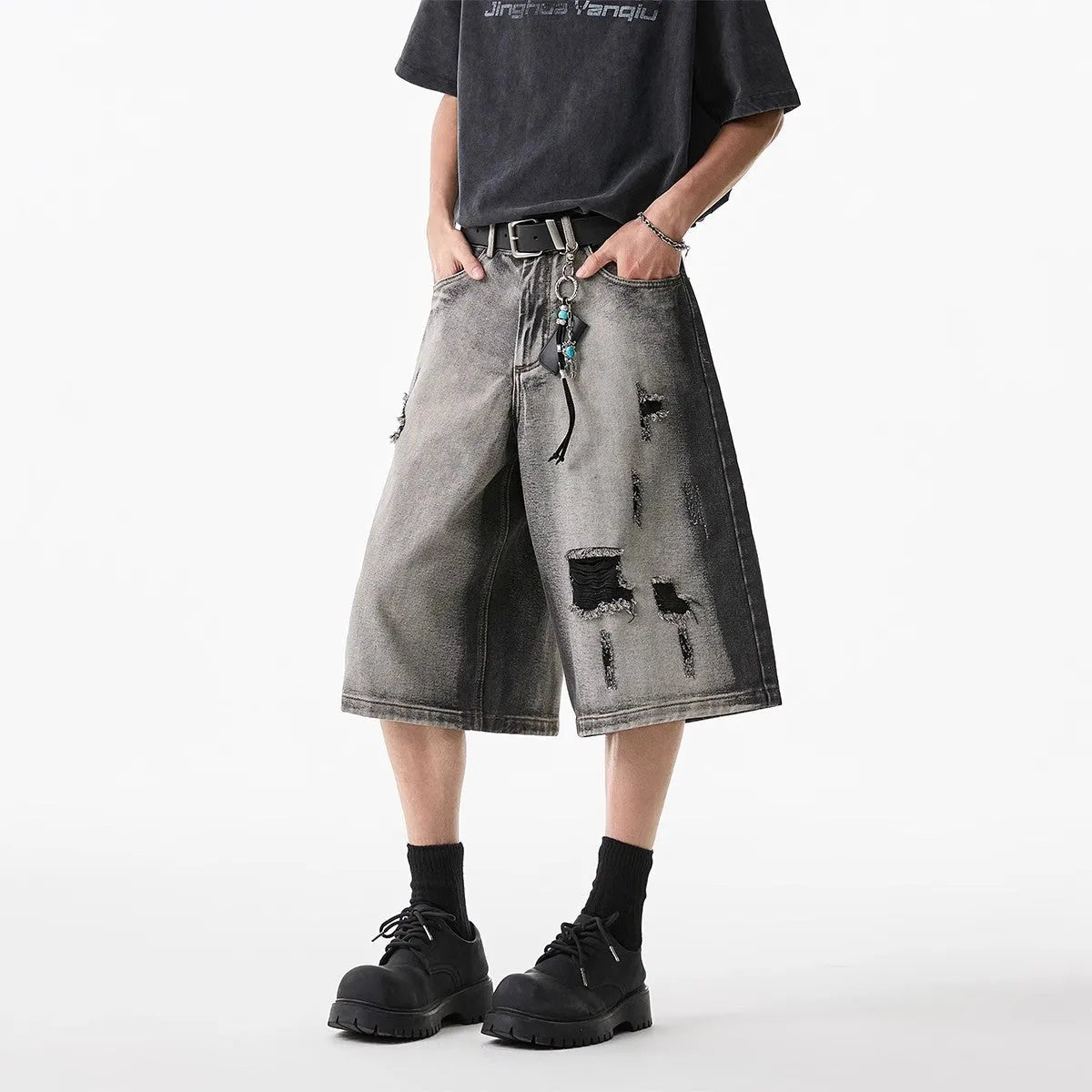 Grey water washed denim shorts with hole detailing and loose cropped fit
