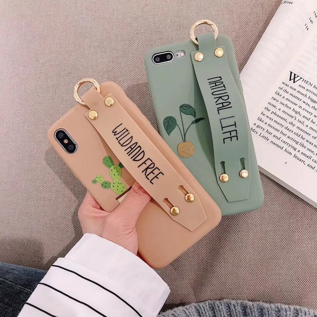 Green wristband holder phone case with graffiti design for iPhone, showing the integrated carrying loop.
