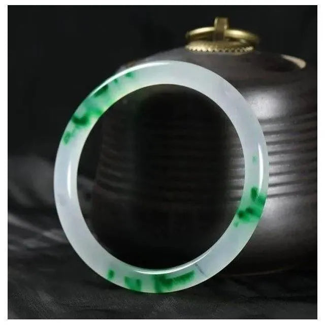 Jade bracelet with floating flower design and auspicious cloud patterns in ice-like emerald finish