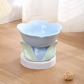 Blue floral patterned ceramic raised pet bowl with non-slip base for cats or small dogs.