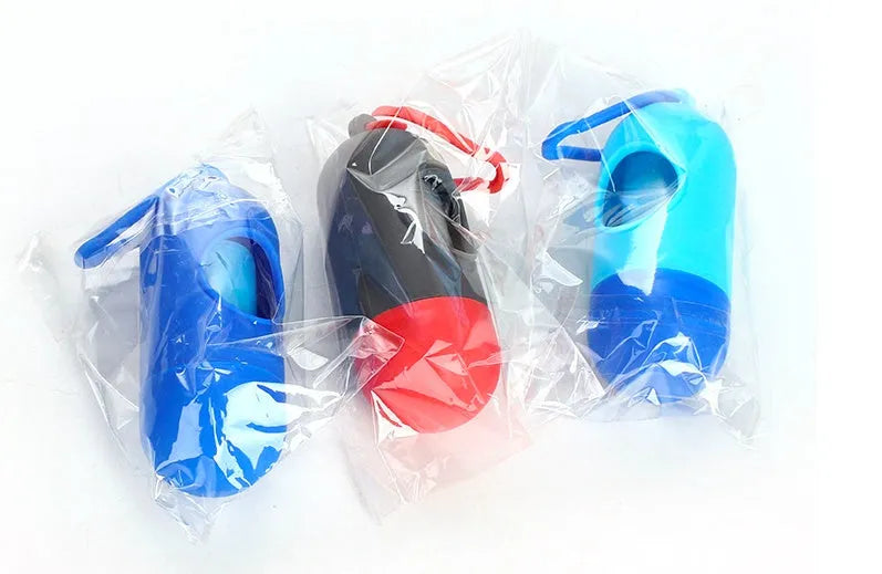 Roll of coloured disposable pet waste bags showing black, blue, green, light blue, pink, and purple options.