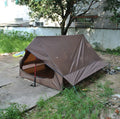 Brown A-line pole-free portable tent with hiking cane support showing interior space for 2-3 people