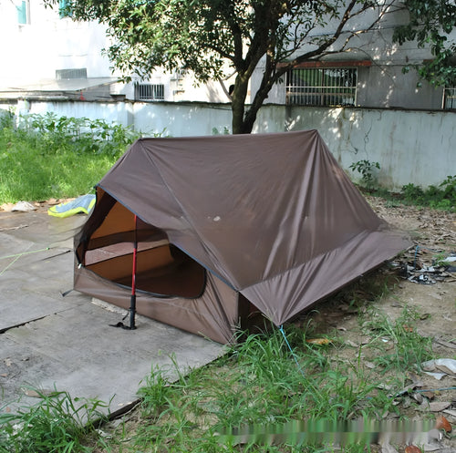 Brown A-line pole-free portable tent with hiking cane support showing interior space for 2-3 people