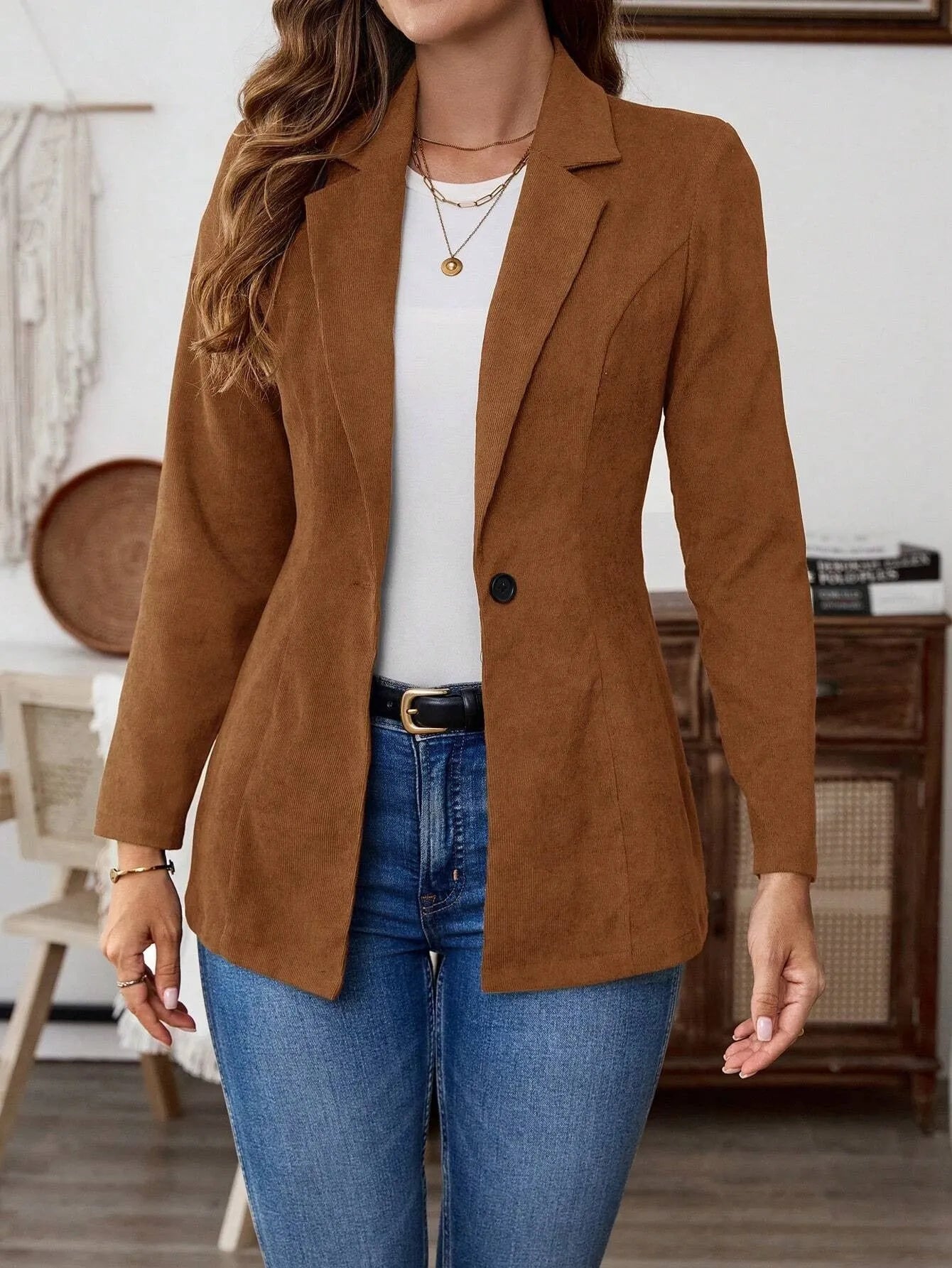Brown men's single-breasted suit coat with lapels and long sleeves on a hanger