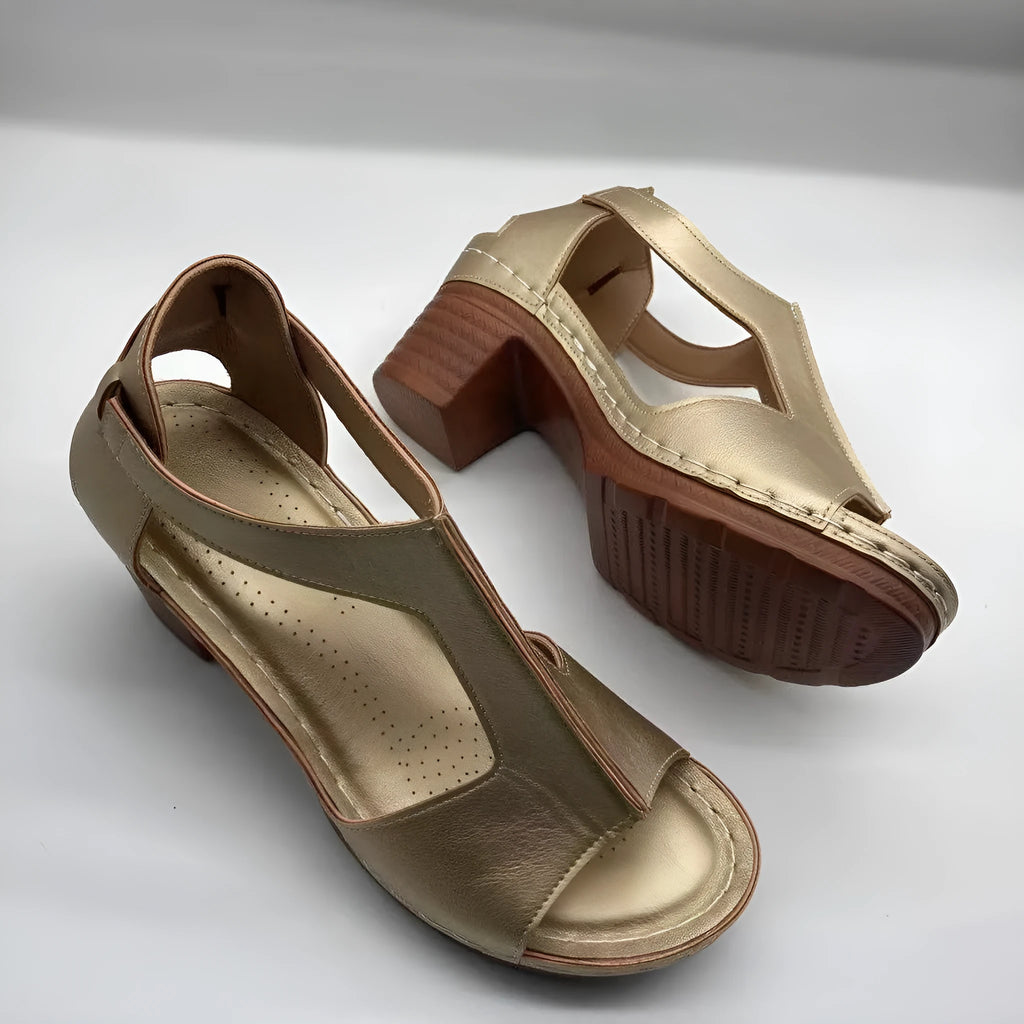 Women's beige peep toe wedge sandals with a buckle strap and low Roman-style heel.