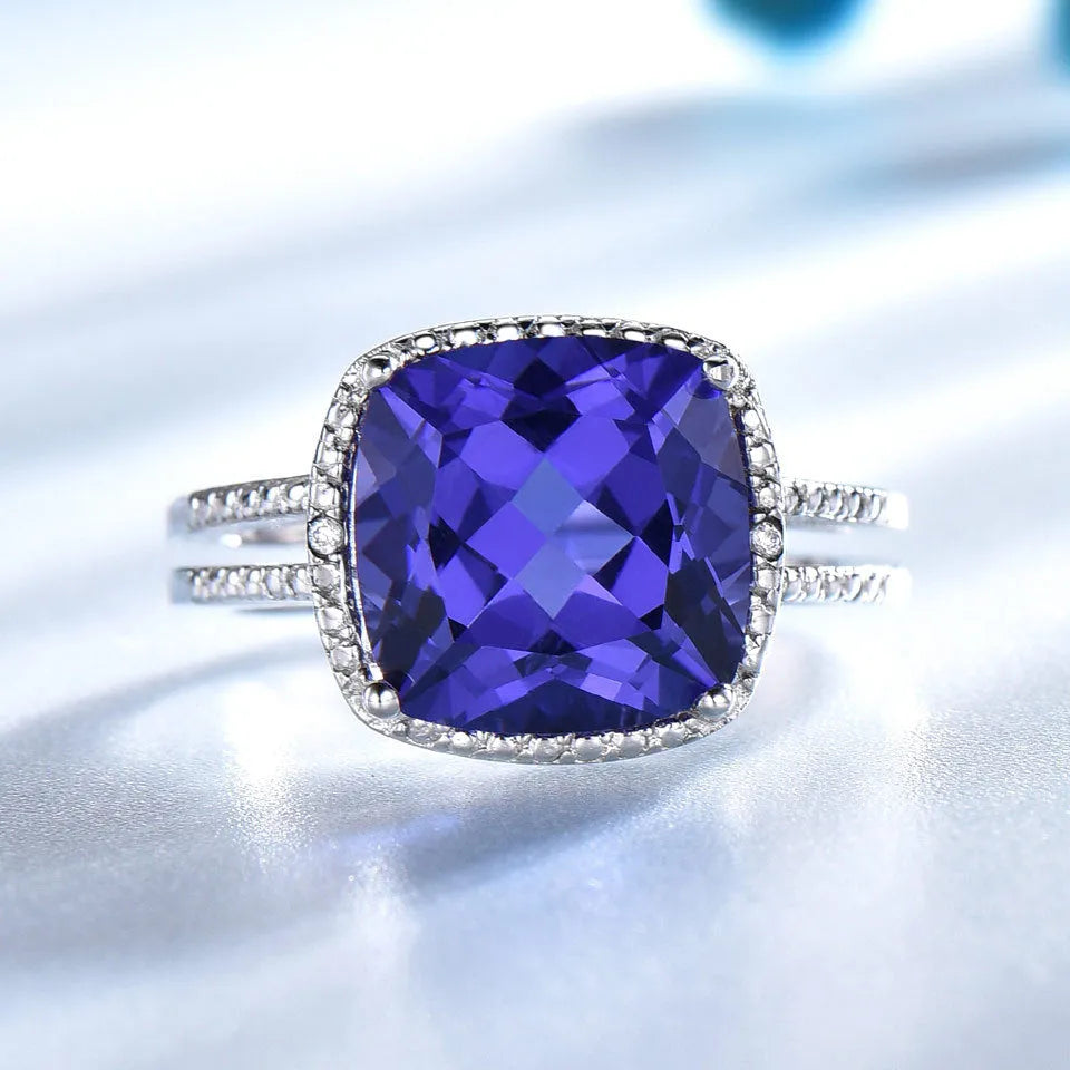 Women's sterling silver ring with a blue Tanzanite gemstone, shown in UK size options 6 to 10.