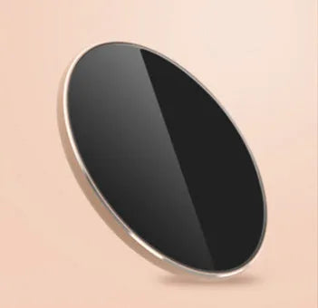 Slim aluminium wireless charging pad in rose gold colour on a wooden surface
