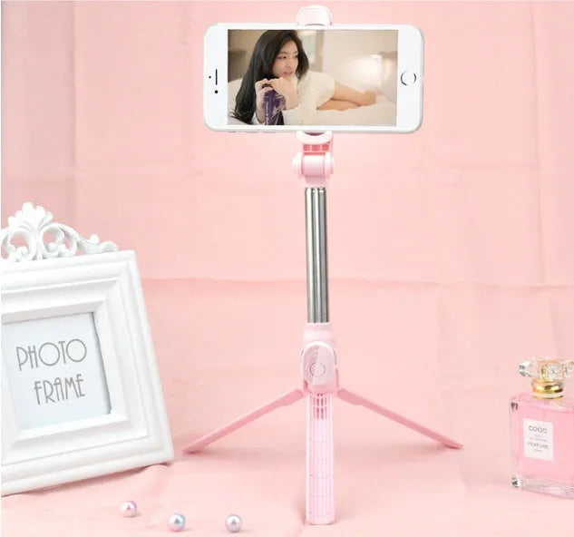Bluetooth remote control mobile phone tripod stand extended with phone attached