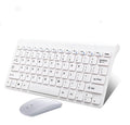 Black and white wireless keyboard and mouse set with USB receiver on wooden desk