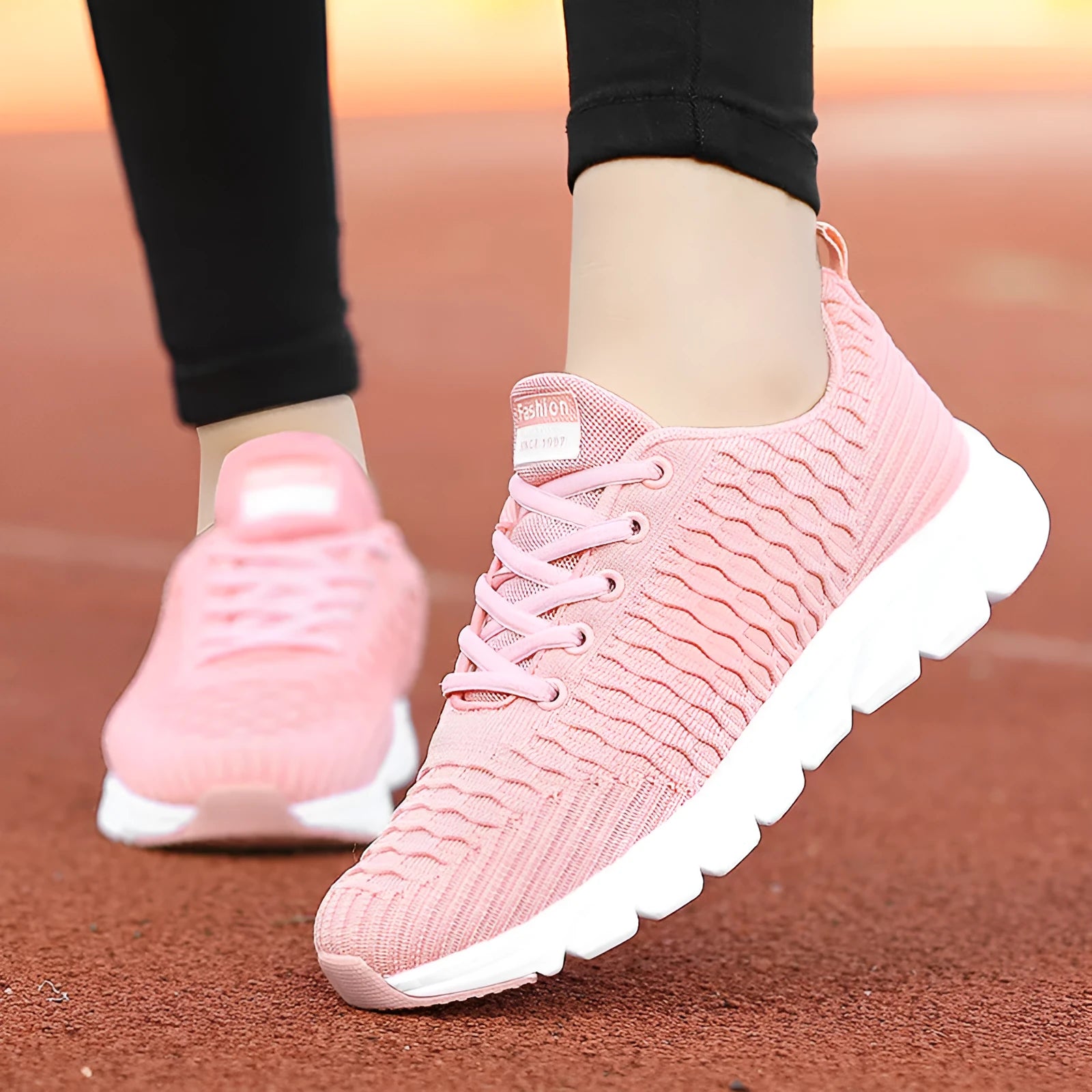 Women's running shoes with a fly weave upper in black, pink, and white colour options on a wear-resistant outsole.
