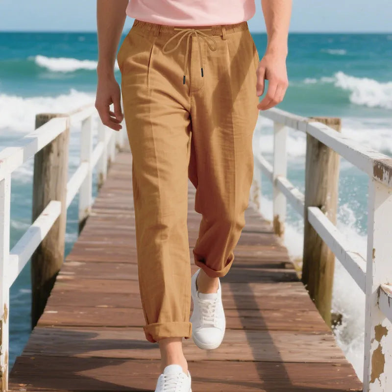 Men's light khaki linen casual trousers with a drawstring waist and straight-leg fit on a hanger.