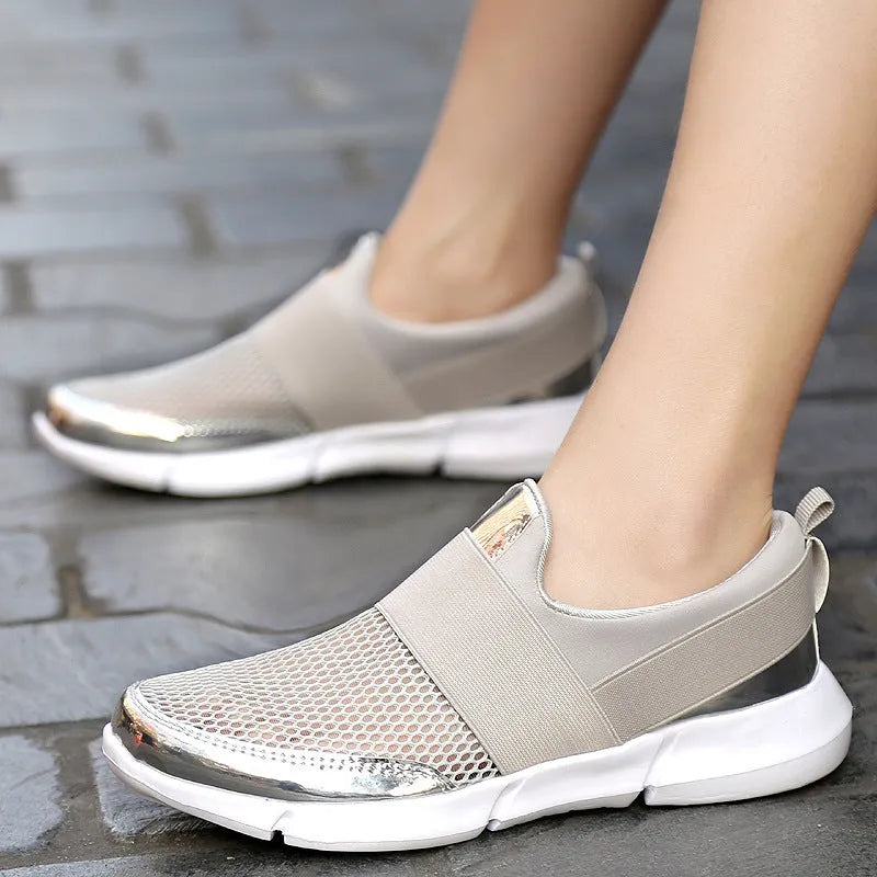 Blue, black, and grey women's low-top sneakers with a mesh lining and lightweight design.