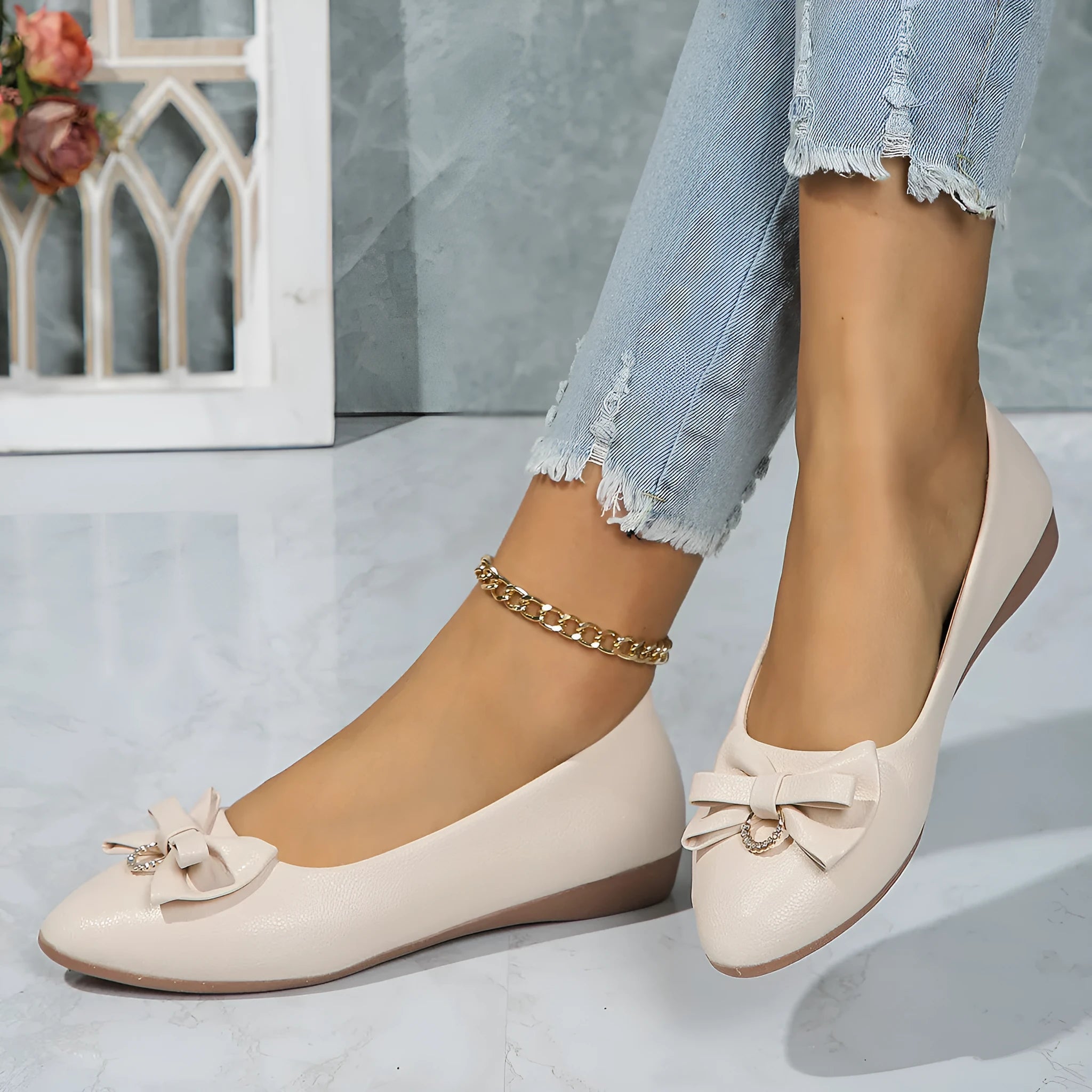 Women's beige flat casual slip-on shoes with a bowknot and shallow mouth design on a white background.