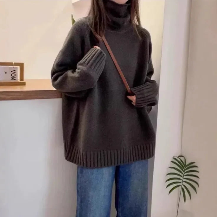 Women's thick loose-fit turtleneck sweater with curling pile collar in red, camel, grey, or black.