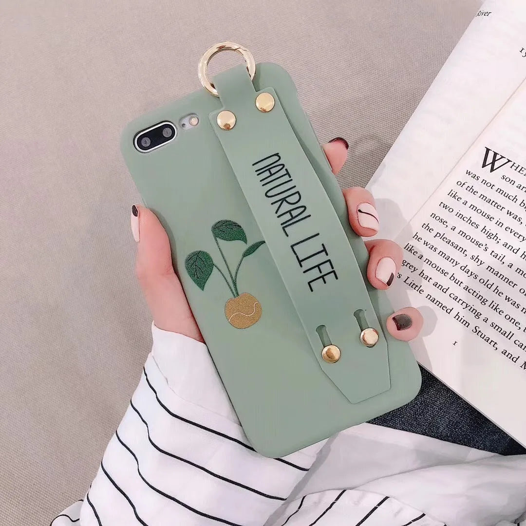 Green wristband holder phone case with graffiti design for iPhone, showing the integrated carrying loop.