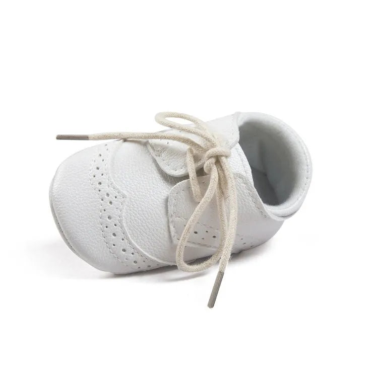 Vintage style soft-soled baby shoes for boys in synthetic leather, available in black, grey, light brown, and white.