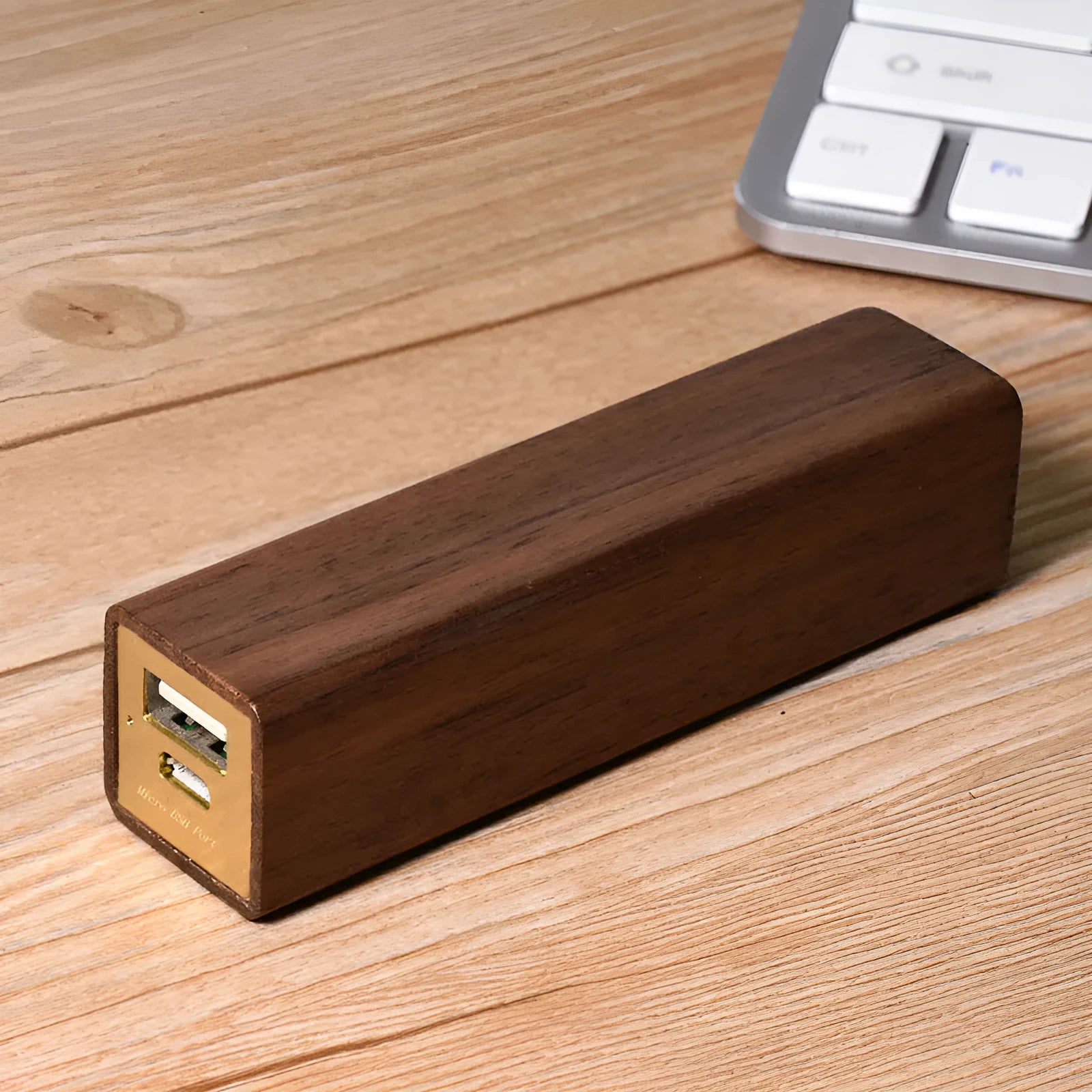 Brown walnut wood portable power bank showing its rectangular shape and natural wood grain.