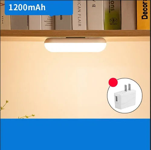 White and black portable magnetic LED desk lamp with adjustable dimming on a wooden desk