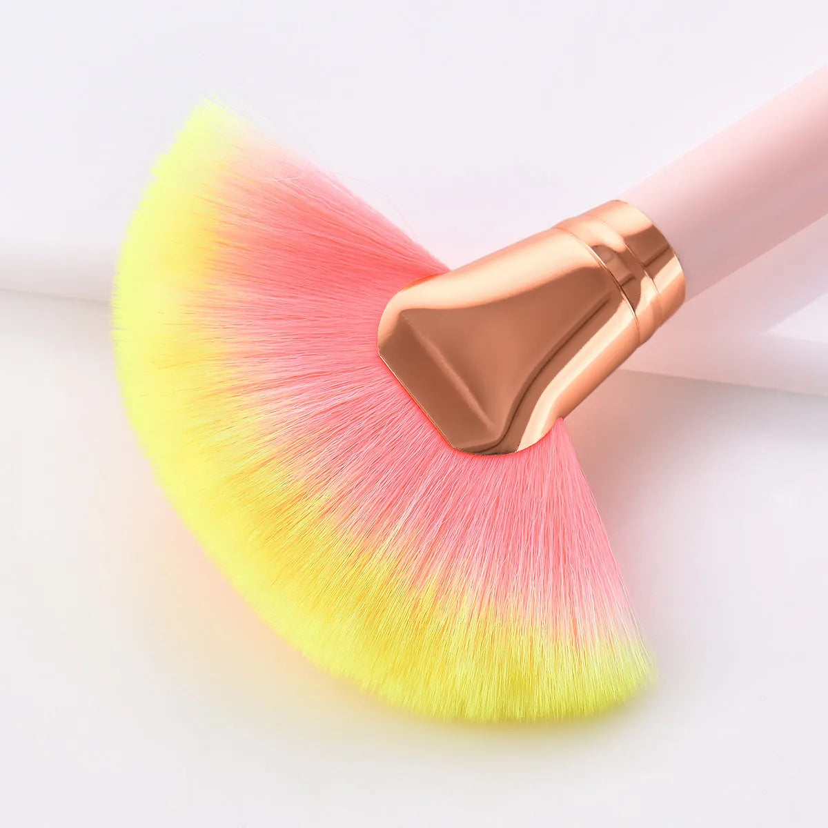 Pink 10-piece makeup brush set with nylon wool bristles and wooden handles laid out on a flat surface