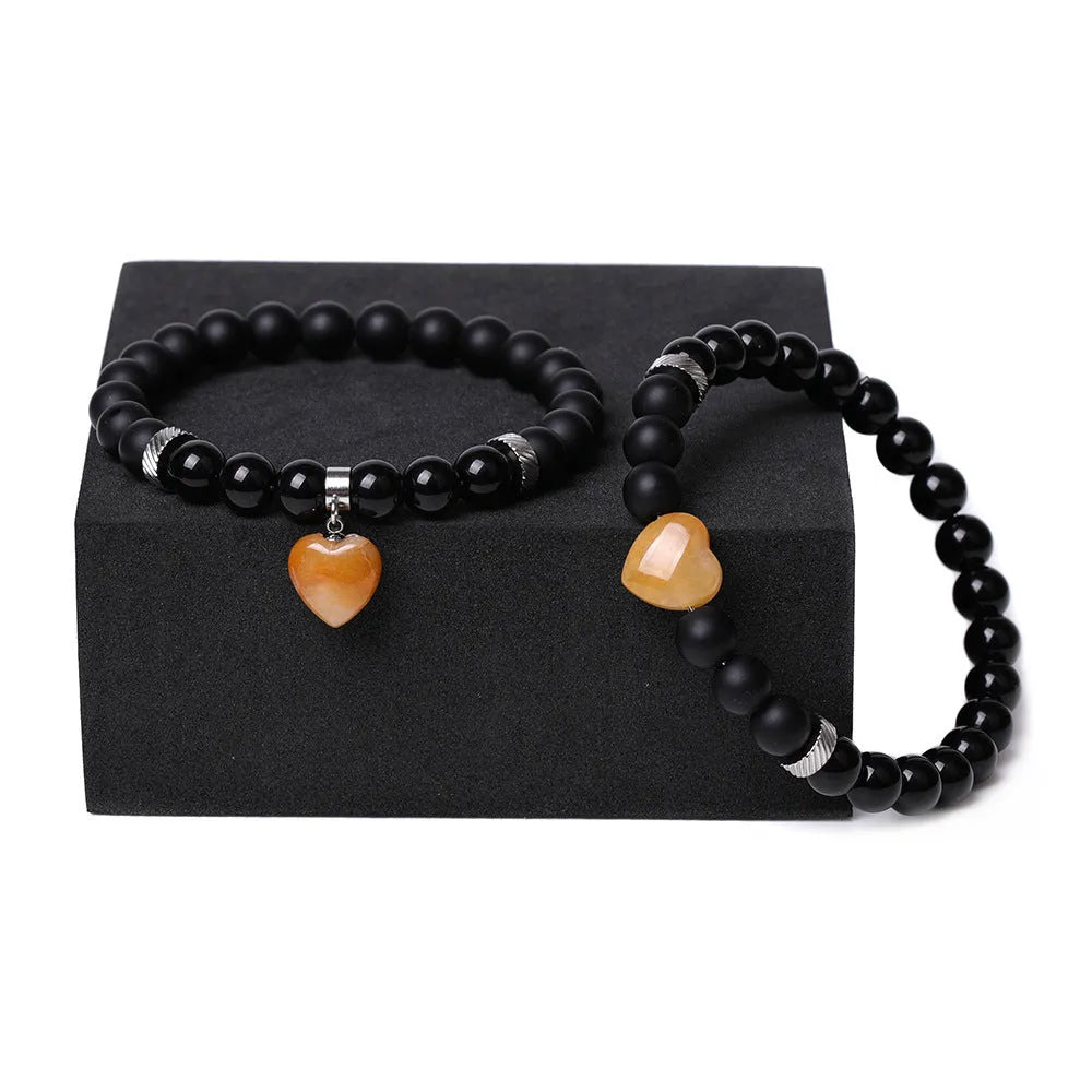 Natural stone couple bracelet set showing two matching bracelets with heart-shaped polished stone charms