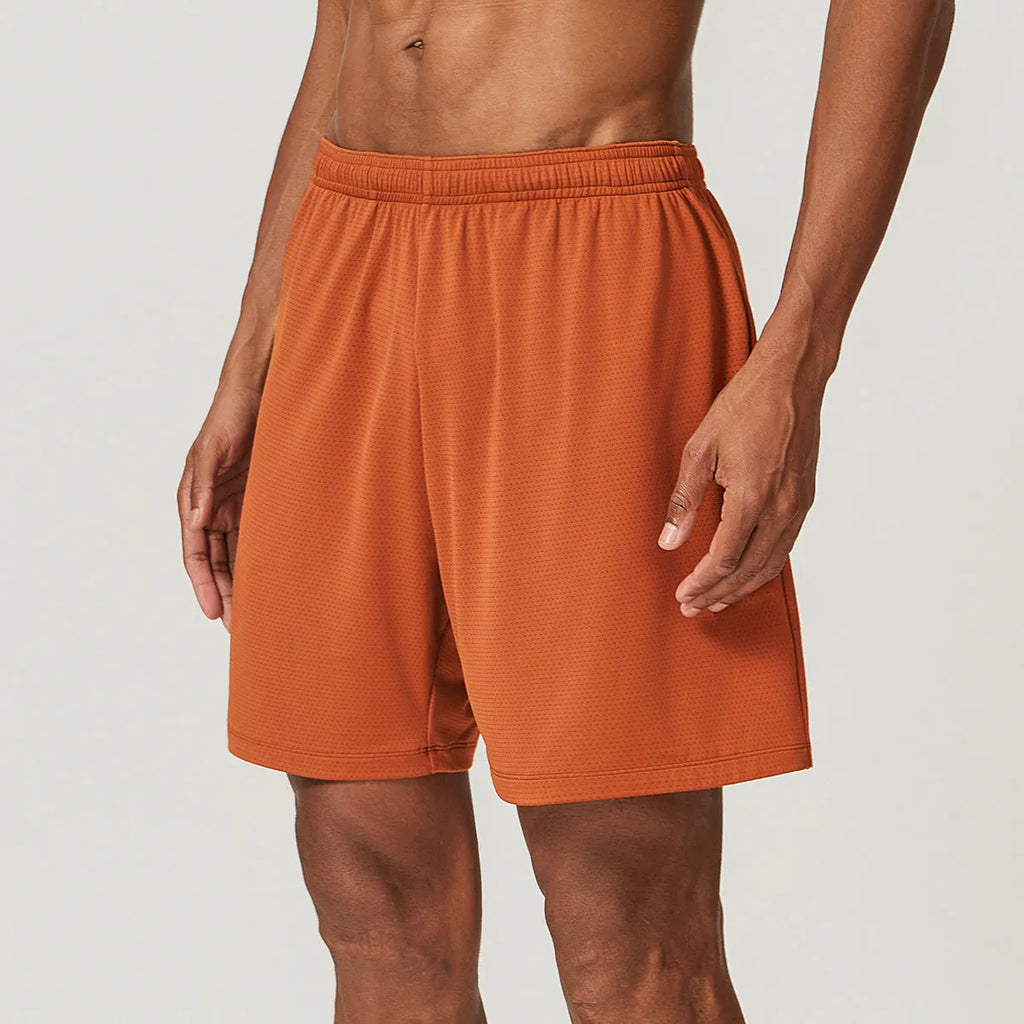 Men's double-layer quick-drying running shorts in brick red colour on a mid-waist model.