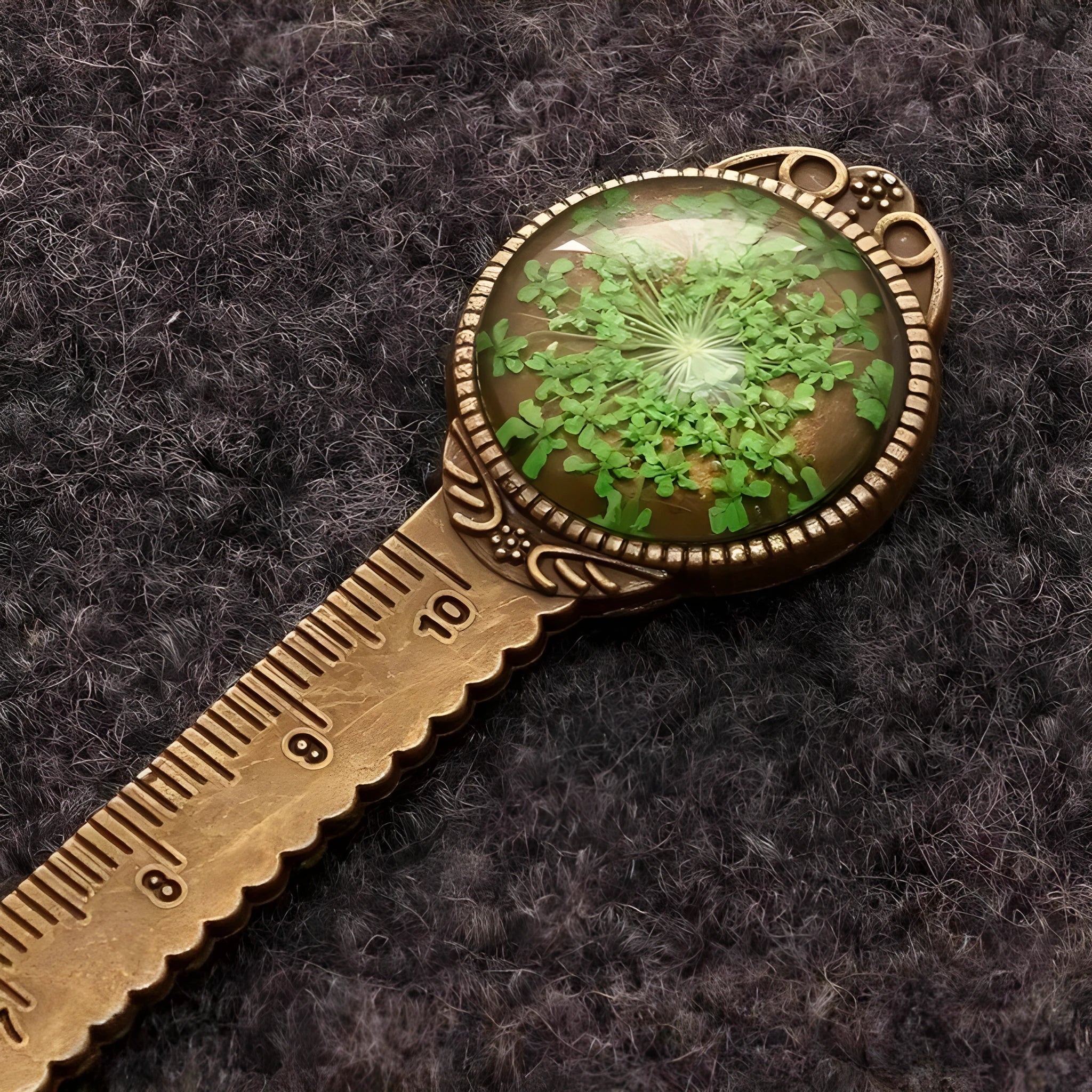 Handmade dried flower bookmark with lace flowers, daffodils, and clover, measuring 12cm long, on a book.