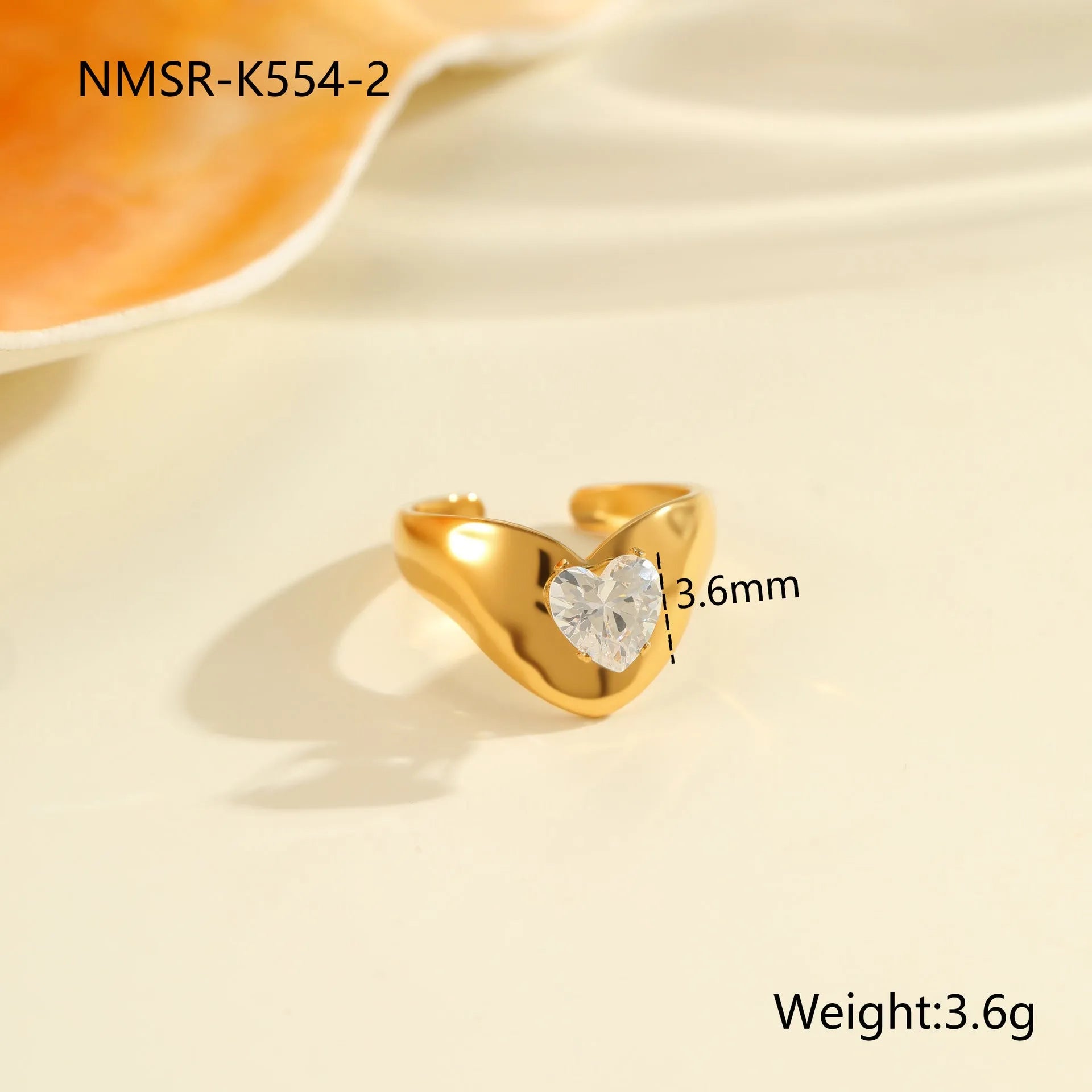 Geometric stainless steel zircon ring with open mouth design on a hand.