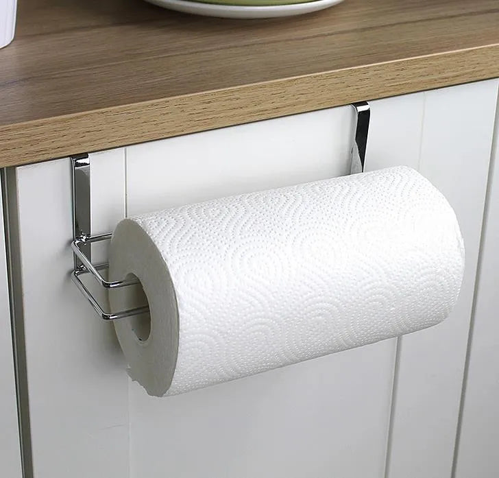 Silver stainless steel paper towel rack mounted on a kitchen cabinet door
