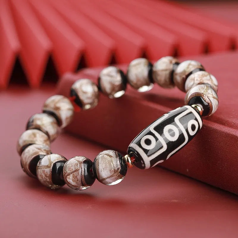 Close-up of a coloured glaze bracelet with traditional Chinese snake design and multi-coloured beads.
