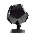 LED star projector night light showing constellation projection on a bedroom ceiling with remote control.