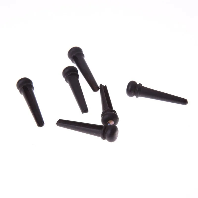 Six black matt ebony guitar bridge pins with solid string cone design